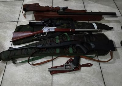 Entre as armas est&aacute; um fuzil Taurus T4 (calibre 5,56) encontrado sobre um guarda-roupa