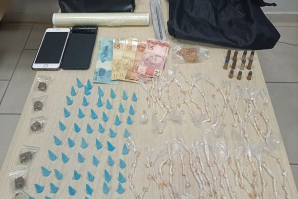No interior da resid&ecirc;ncia foram apreendidos pinos de coca&iacute;na, por&ccedil;&otilde;es de maconha, dinheiro em esp&eacute;cie, facas com res&iacute;duos de entorpecente, dois celulares e muni&ccedil;&otilde;es de calibre .38